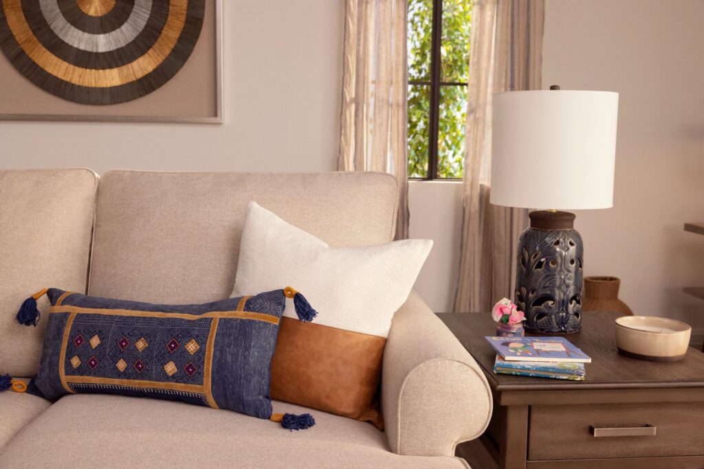 two decorative pillows on a beige sofa